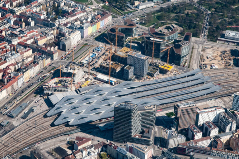 Aerial view of building construction beside roads and neighbouring properties